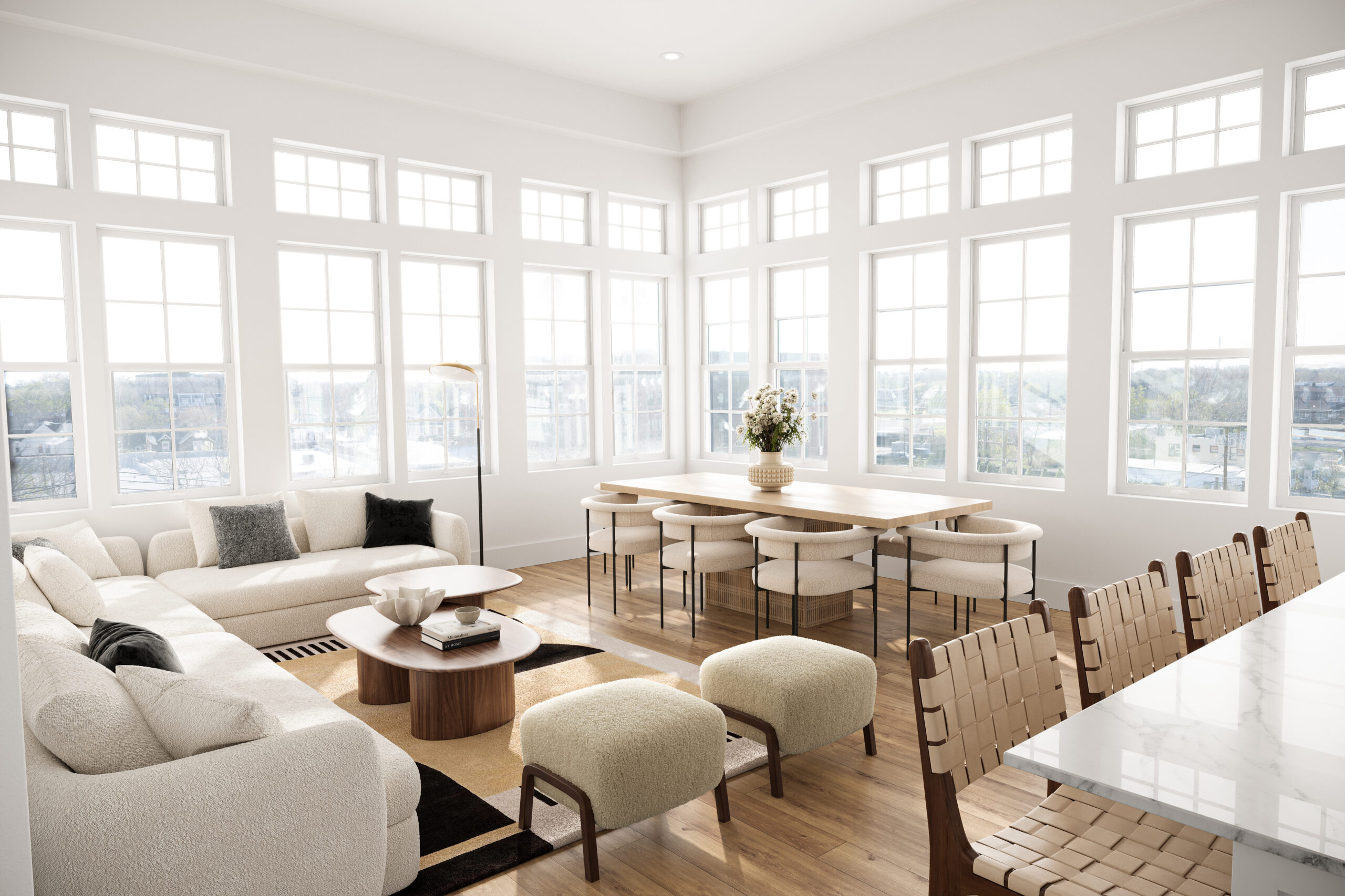 Resident lounge at Shoregate Apartments in Bay Shore, featuring wood grain floor paneling and cream colored couches.