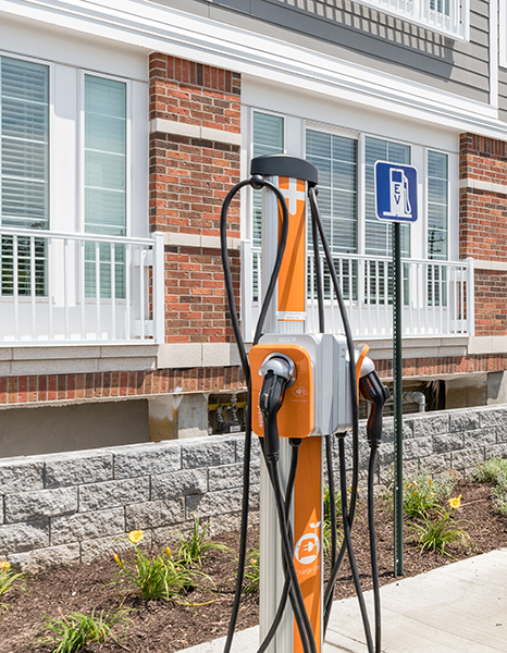 EV Charging station at Shoregate Apartments in Bay Shore, featuring a view of the apartment exteriors and balconies.
